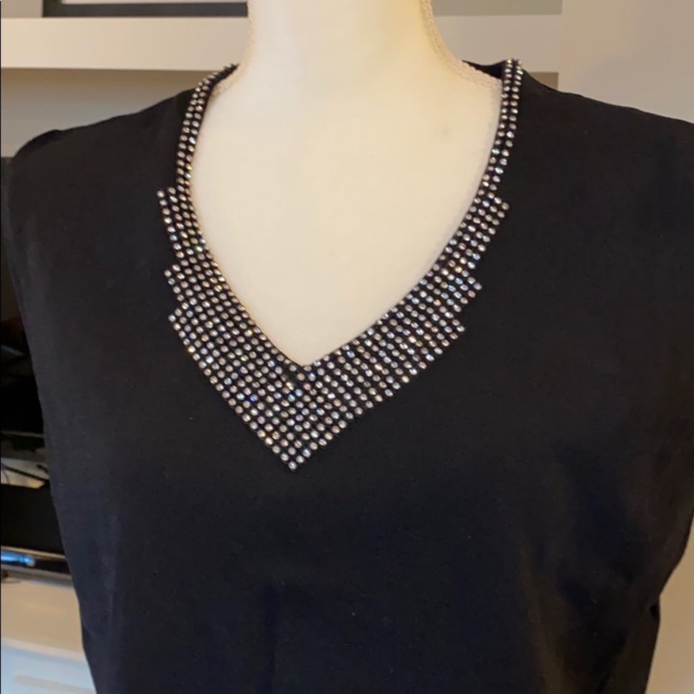 Sleeveless black top with V-neck rhinestones.
